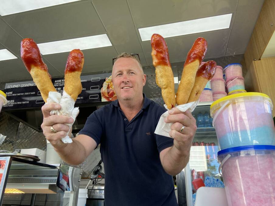 FRIED GOLDEN: Josh Evans with freshly cooked Dagwood Dogs at Orange Showground on Wednesday morning. Photo: PETER HOLMES.