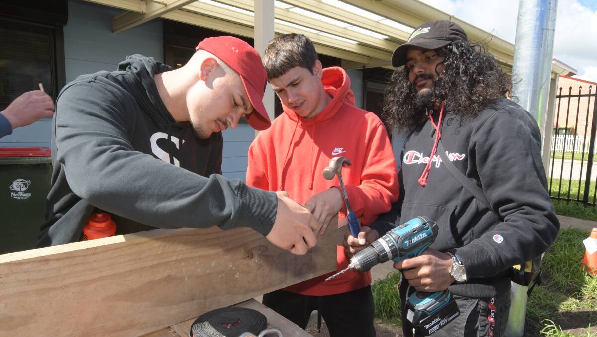 FOCUS: Kyran Ah-See, Andrew Catmore and Trey Lucas on the tools at the TAFE course in Glenroi. Photo: JUDE KEOGH.