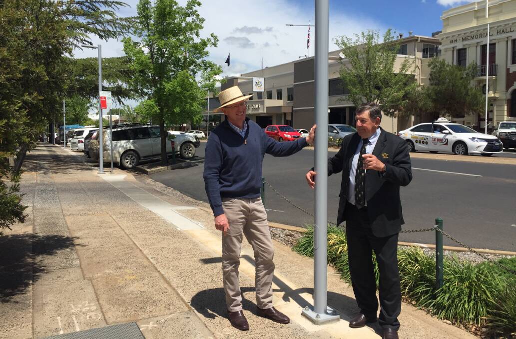 POLE POSITION: Federal MP Andrew Gee and Orange mayor Reg Kidd come to grips with one of the new energy-saving lights on Anson Street. Photo: PETER HOLMES.