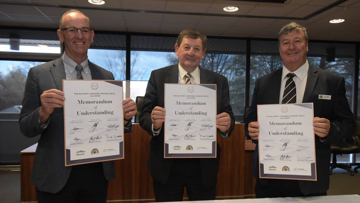 PEN FRIENDS: Mayors from Blayney (Scott Ferguson), Orange (Reg Kidd) and Cabonne (Kevin Beatty) with their agreement. Photo: JUDE KEOGH