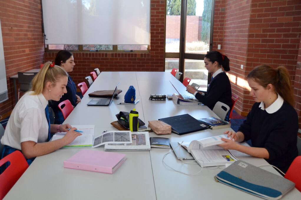 Year 12 students studying in the library.