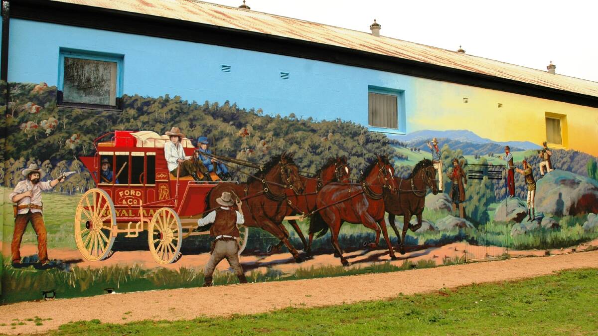 LOOKING GOOD: One of the murals on buildings at Eugowra showing the bushrangers' hold-up at Escort Rock.