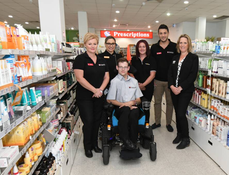 HE'S EMPLOYED: Jason Roberts with Kylie McCloskey, Kristen Hunter and Stacey Powe from Live Better, pharmacist Mike Wehbi and Rebecca Plant. Photo: JUDE KEOGH 0321jkjason1