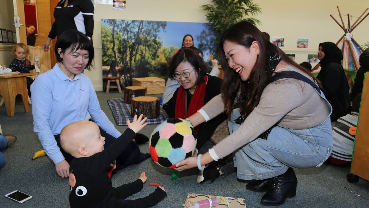 HAVING A BALL: Ye Ling, Mao Hongmei, and Huang Hongyan with Owen Agars at TAFE NSW Orange early childhood education and care centre.