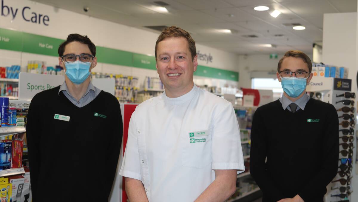SAFE: "There has been a little bit of concern with requests for masks," says pharmacist Tim Gray (centre) with Matthew Peirce and Josh Batty.