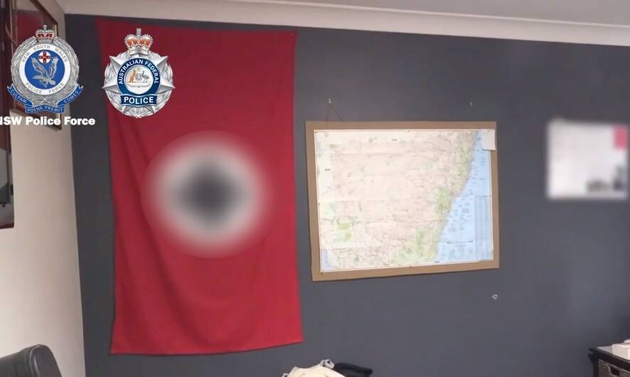 Footage provided by police shows a Nazi flag, not thought to be Priest's, hanging in a bedroom of the property raided on Friday. Photo: NSW POLICE
