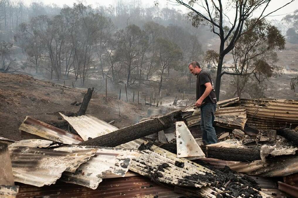 Gone: Wyndham General Store owner Peter White surveys what's left of the shed at the rear of his New Buildings Road property after Saturday's intense blaze. Picture: Michael Weinhardt
