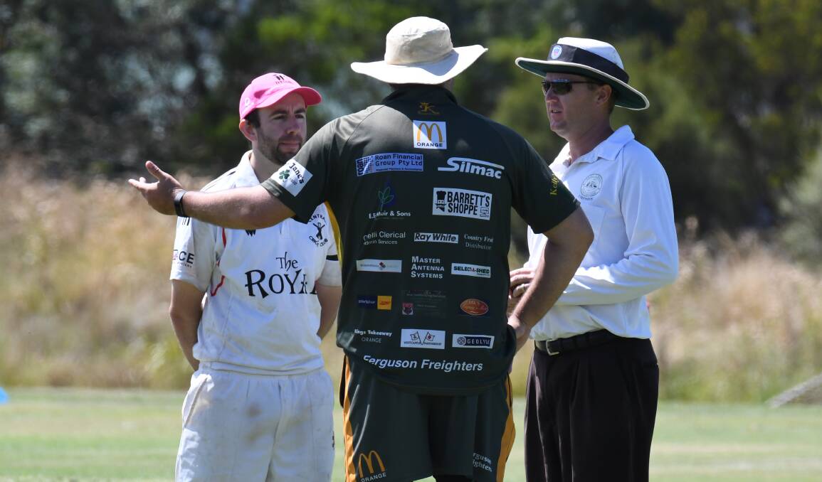 DISCUSSIONS: Centrals president and player Matt Tedeschi and CYMS captain Chris Novak, in discussion with umpire Matt Tabbernor, who was officiating on the adjacent field. Photo: JUDE KEOGH
