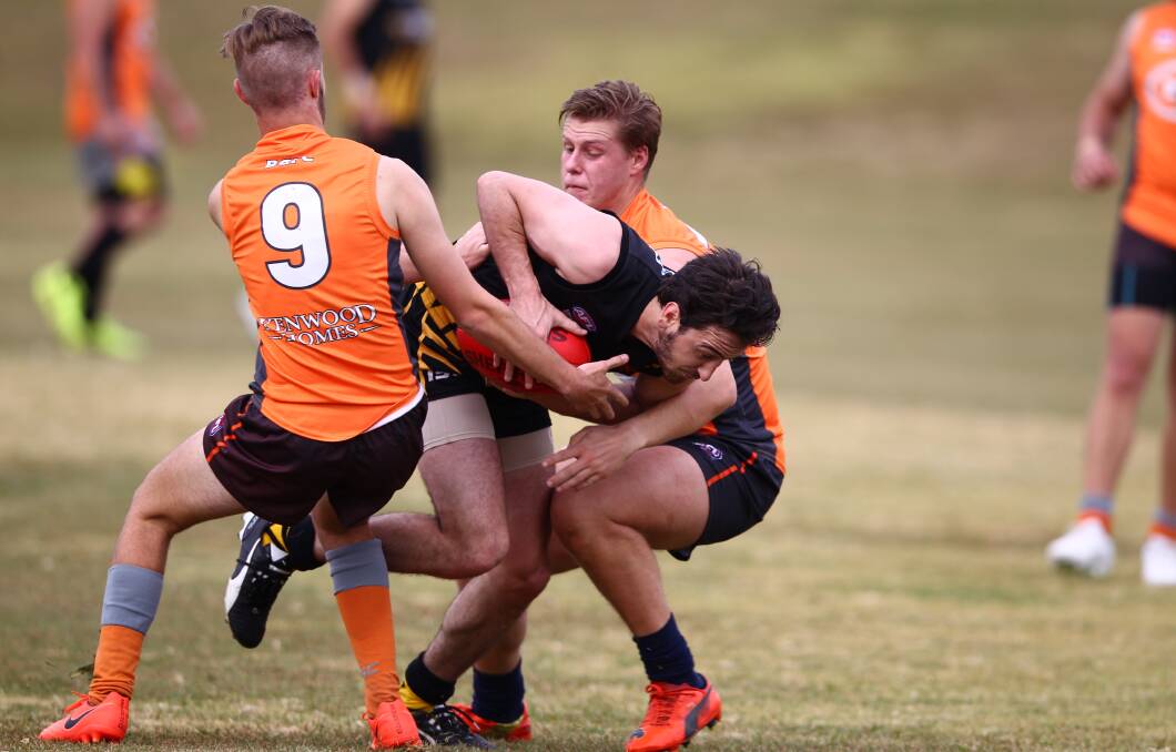 FIGHTING THROUGH TRAFFIC: Orange Tigers star Jaxon Mumme flies into a challenge against the Bathurst Giants, he kicked two majors on Saturday. Photo: PHIL BLATCH