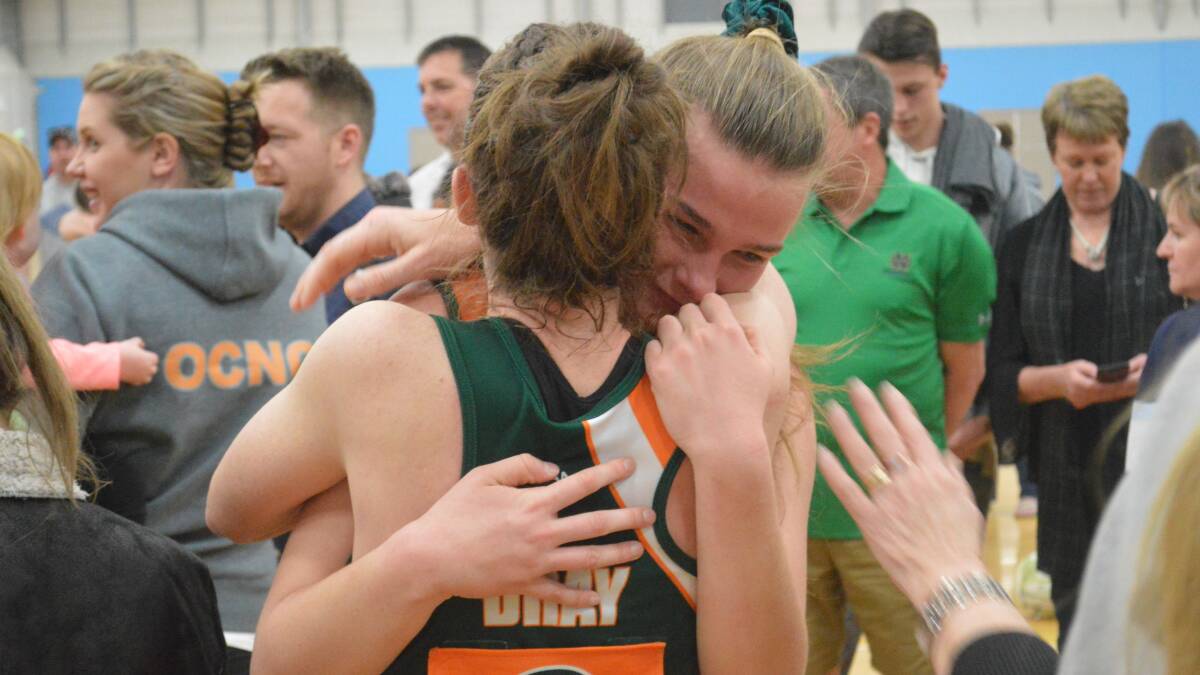 SHINING STAR: Milly Wilcox embraces her skipper Tegan Dray after Saturday's incredible grand final win. She was named player-of-the-final. Photo: MATT FINDLAY