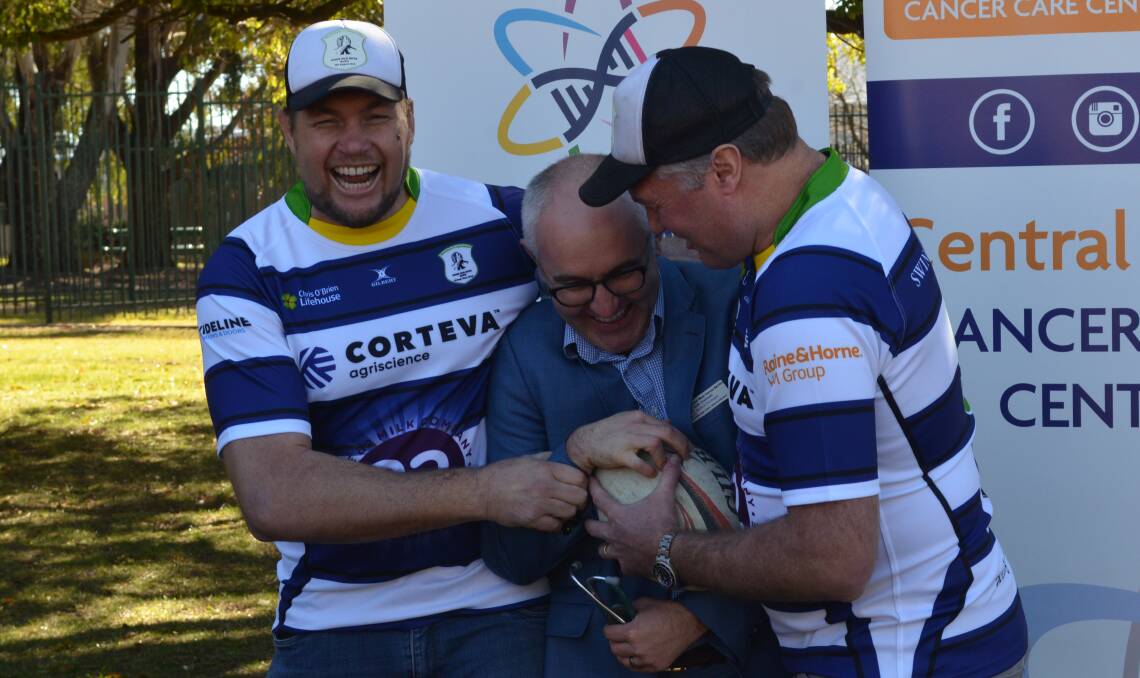 COMMUNITY CAUSE: BrothersIVBrothers founders Bryn Robertson (left) and Jason Robertson (right) have a laugh with Dr Rob Zielinski ahead of next week's charity game. Photo: MATT FINDLAY 0704mfcharityrugby2