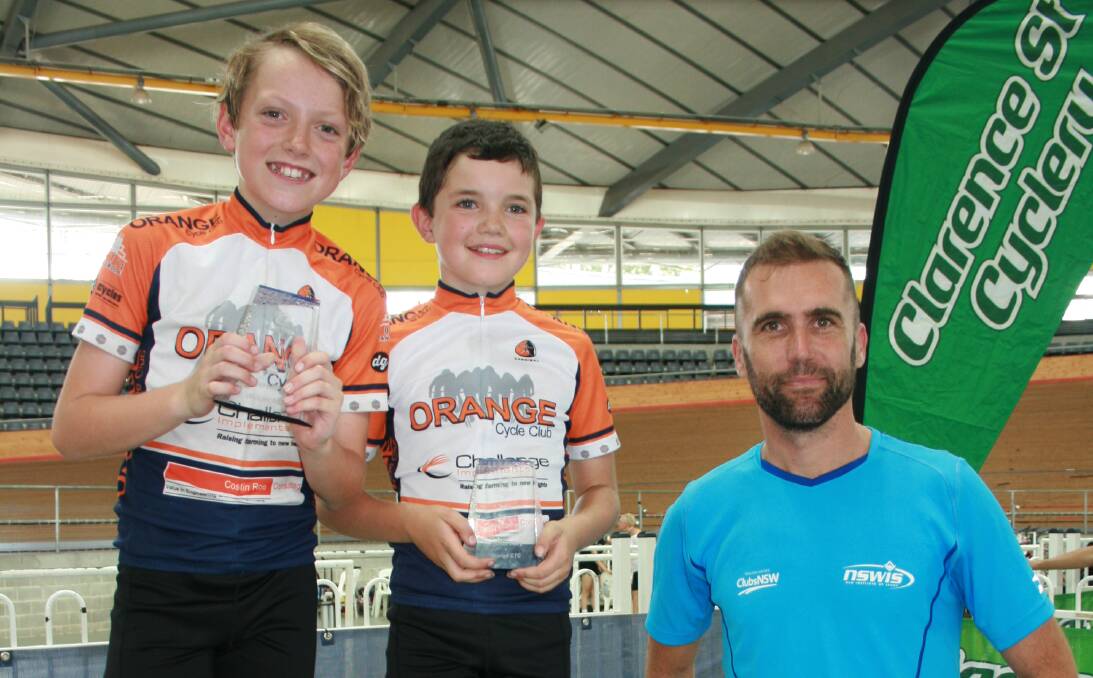 WILD RIDE: Xavier Bland and Gydion Dally receive their Cyclist of the Year awards from NSW Institute of Sport head coach Brad McGee last weekend. Photo: CONTRIBUTED