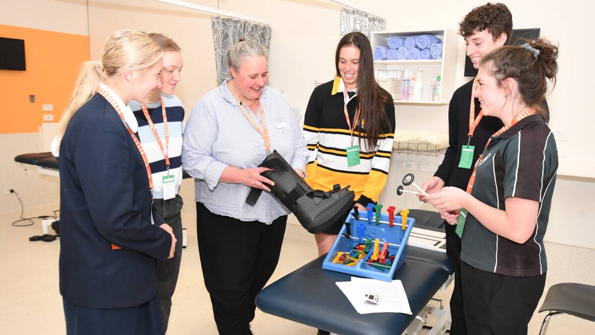 PRACTICAL LEARNING: Central West students Lily Martin, Sophie Strong, Claudia Smith, Liam Curran and Caitlin Smith-Gronow run through a physiotherapy workshop with Kerstin McPherson (middle).Photo: JUDE KEOGH