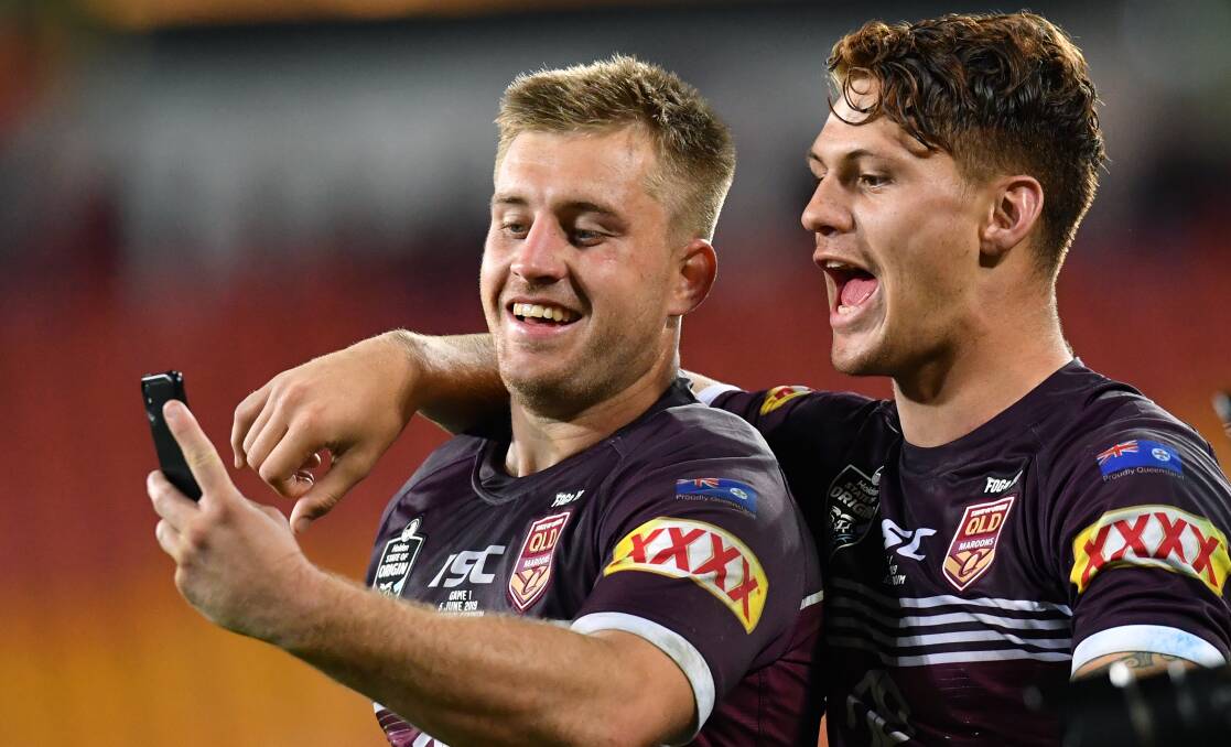 THE STARS: Cameron Munster and Kalyn Ponga take a selfie after Queensland's game one win, they were both superb. Photo: AAP/DARREN ENGLAND