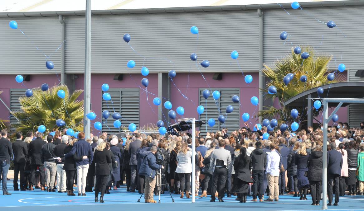 FAREWELL: Blue balloons are released in honour of Orange teenager John Keegan during his funeral service at the PCYC on Friday morning. Photo: JUDE KEOGH