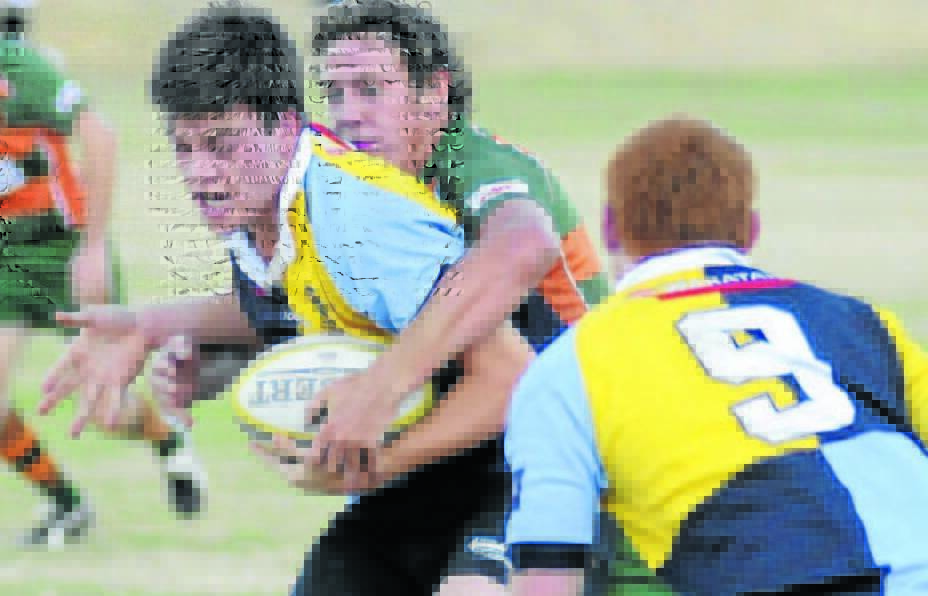 ABOVE HIS WEIGHT: Hugh Medway, flanked by halfback Dom Longhurst (foreground), takes on Orange City's line in 2012. Photo: CHRIS SEABROOK