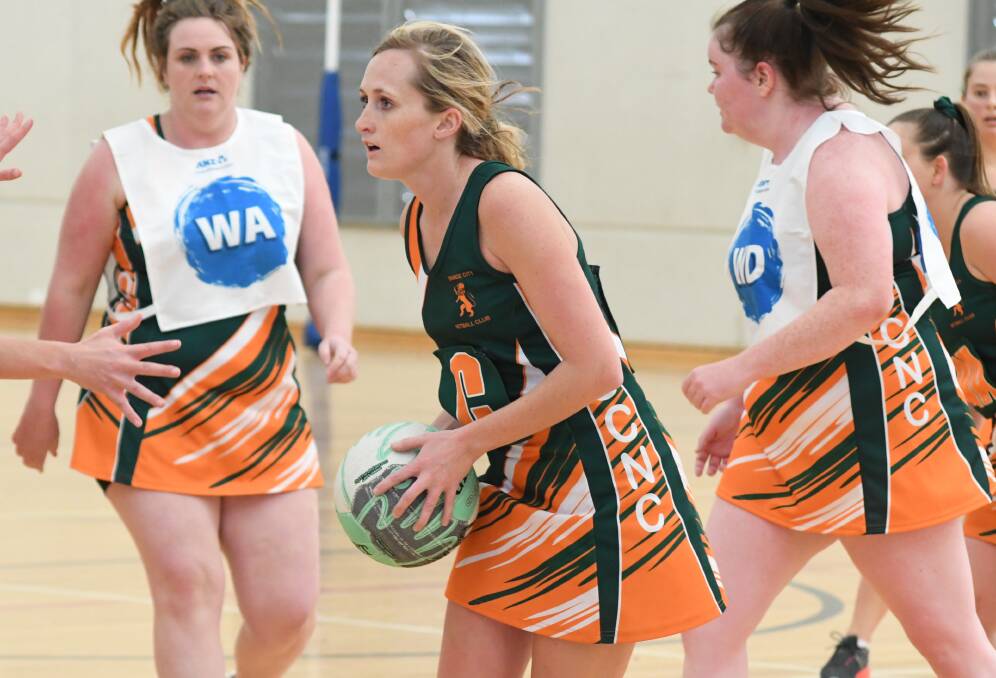 LOOKING UP: Billie-Rae White weighs up her options in last weekend's Orange City derby, Orange Netball Association's fourth division is heating up. Photo: JUDE KEOGH