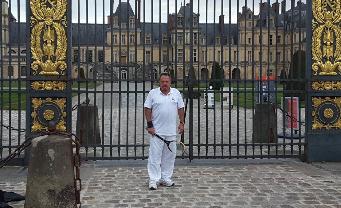 THE SCENE: Chris Doucas poses for a shot in front of Château de Fontainebleau's imposing gates, before heading into the palace to claim a tournament win. Photo: CONTRIBUTED