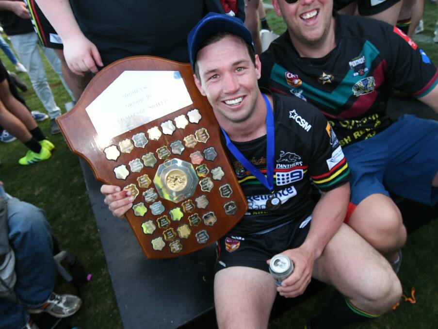 CHAMPIONS AGAIN: Doug Hewitt takes a moment with the premiership shield in 2019. Photo: CHRIS SEABROOK