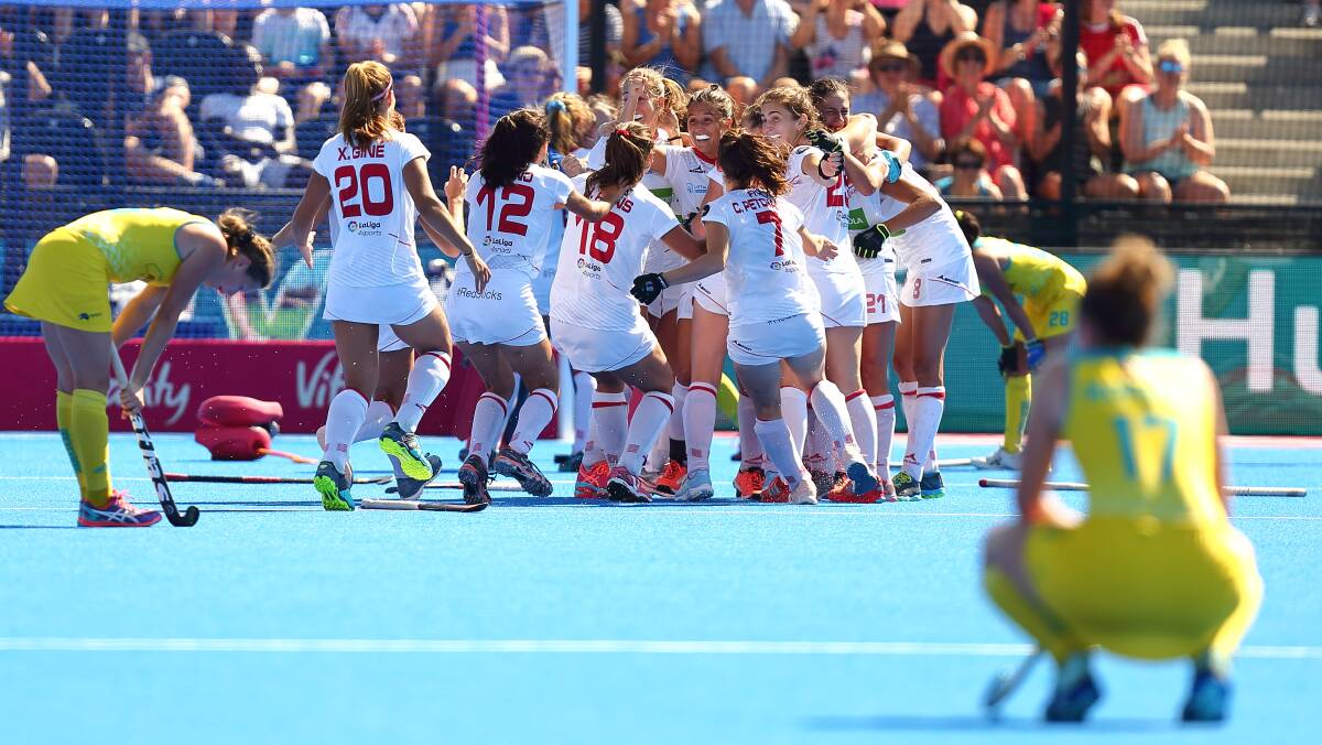 AGONY AND ECSTASY: Spain celebrates while the Hockeyroos lament what could've been in Sunday's bronze medal game. Photo: WORLD SPORT PICS