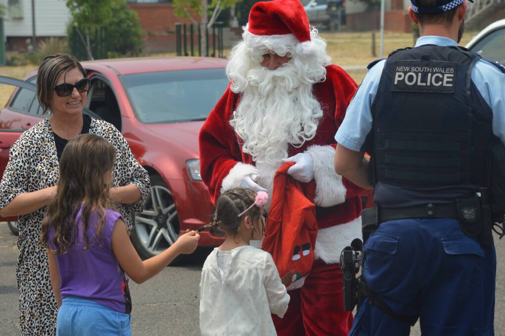 HO, HO, HO: Santa delivers some sweets and festive cheer during the Christmas Eve food drive. Photo: MATT FINDLAY