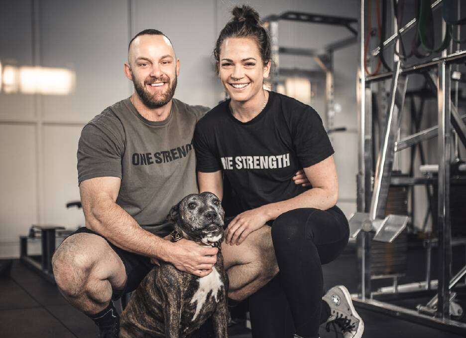 PHYSICAL COMMITTMENT: One Strength owners Lyle Davis and Chantelle Raso, with gym dog Chase, have seen a big upswing in membership since restrictions eased. Photo: ONE STRENGTH