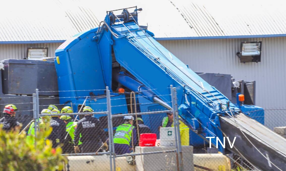 TIPPED: A crane overturned on Edward Street on Friday, a man was taken to hospital as a result. Photo: TOP NOTCH VIDEO/TROY PEARSON