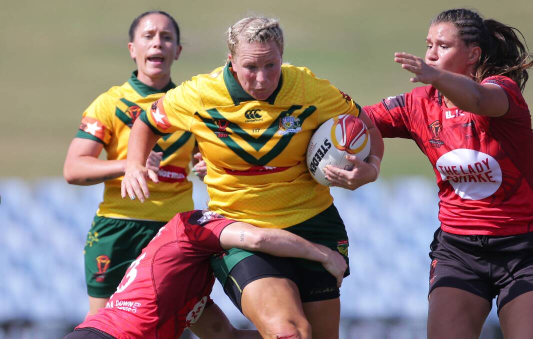 MENTOR: Bec Young charges forward for the Jillaroos. She's excited about the prospect of lining up with the likes of Bec Ford and Majayda Darcy. Photo: JOHN VEAGE