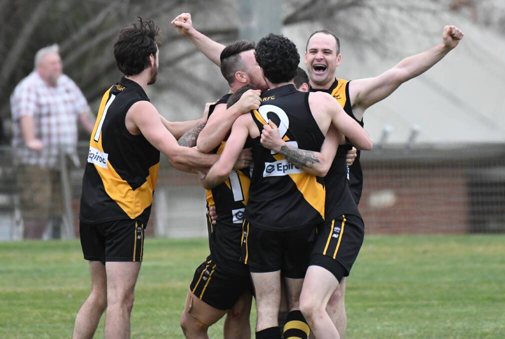 THE HERO: Andrew Henry (back, arms out) celebrates the Tigers' win on Saturday, which he sealed with a match-winning goal. Photo: CHRIS SEABROOK