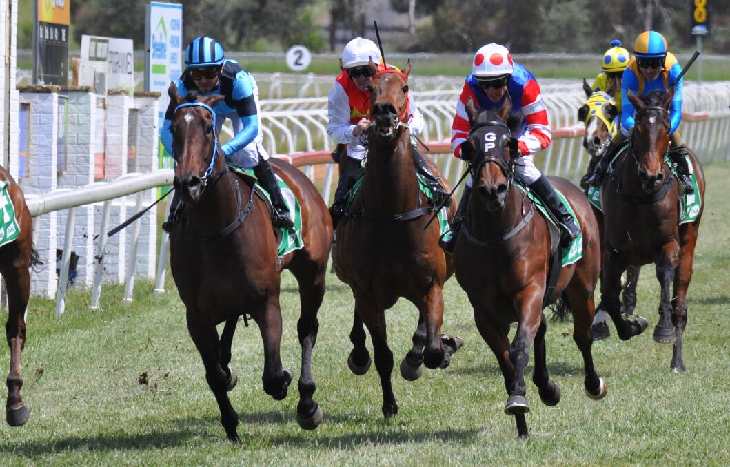 ALMIGHTY RUN: Jake Pracey-Holmes (left, two blue silks) steers Lucy's Legacy to victory in the third at relative outsider odds of $7. Photos: NICK McGRATH