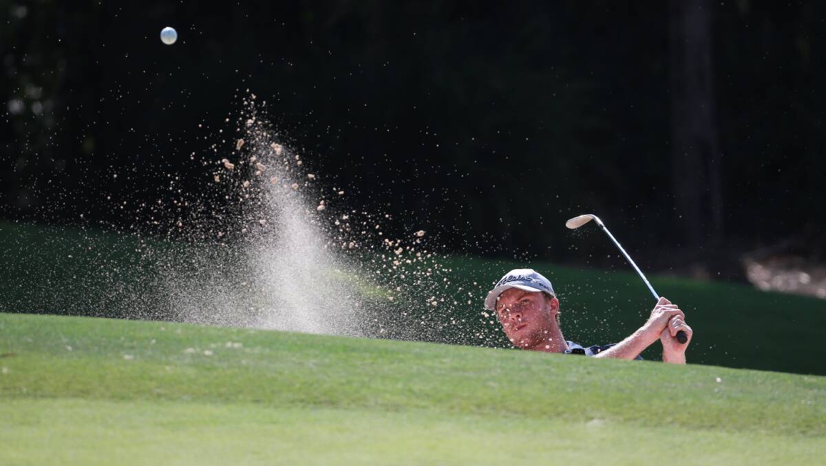 SPLASH: James Conran slashes one out of a bunker at the NSW Amateur Championship in January. Photo: GOLF NSW/DAVID TEASE