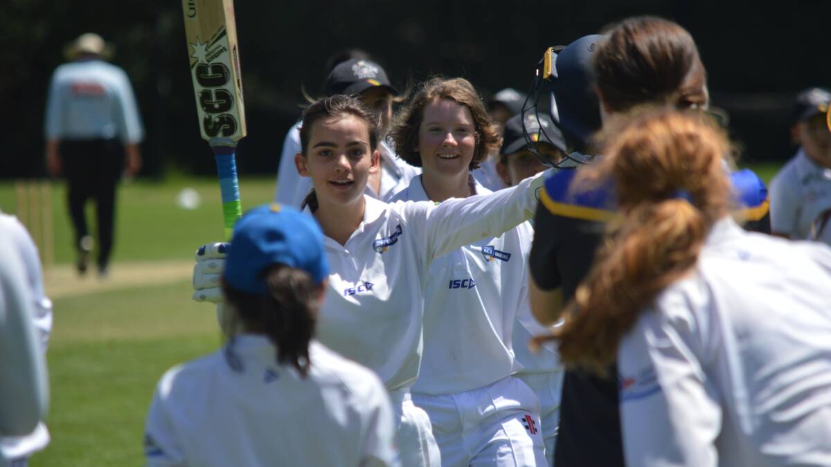 CAPTAIN'S KNOCK: ACT skipper Clare Levings raises her bat as she's tunneled off by her teammates, she finished with a sterling, unbeaten 95 in Tuesday's victory. Photo: MATT FINDLAY
