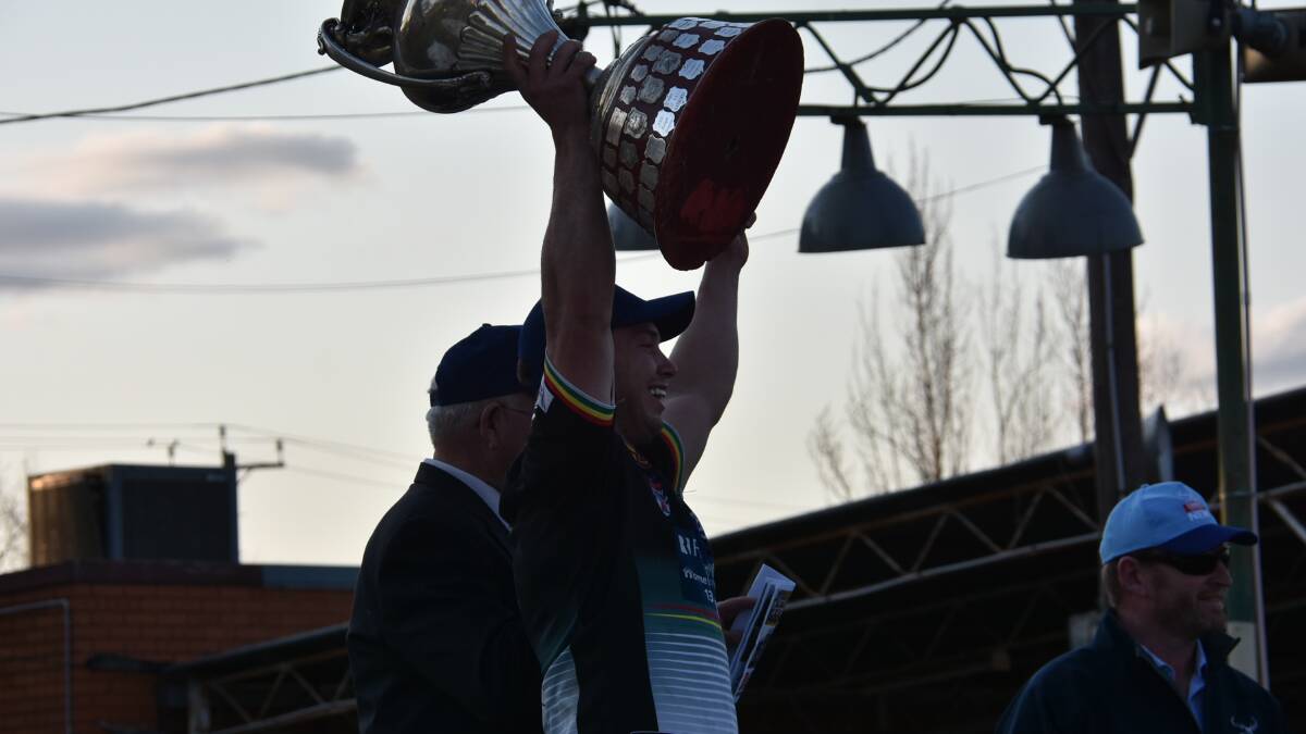 THE DREAM: Panthers captain-coach Doug Hewitt hoists the Western Challenge Cup, to the joy of the Bathurst faithful. Photo: PETER GUTHRIE