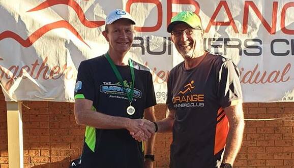 MILESTONE MAN: Daryl Roweth been presented his 700 run medal by vice president Greg Shapter on Wednesday afternoon. Photo: CONTRIBUTED