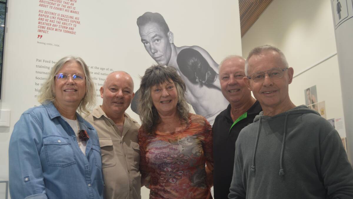 FIGHTING CHANCE: Janine, Bill, Sue, Tony and Paul Ford watched over by the image of their father Pat, whose life and career is being celebrated at the Orange Regional Museum. Photo: MATT FINDLAY