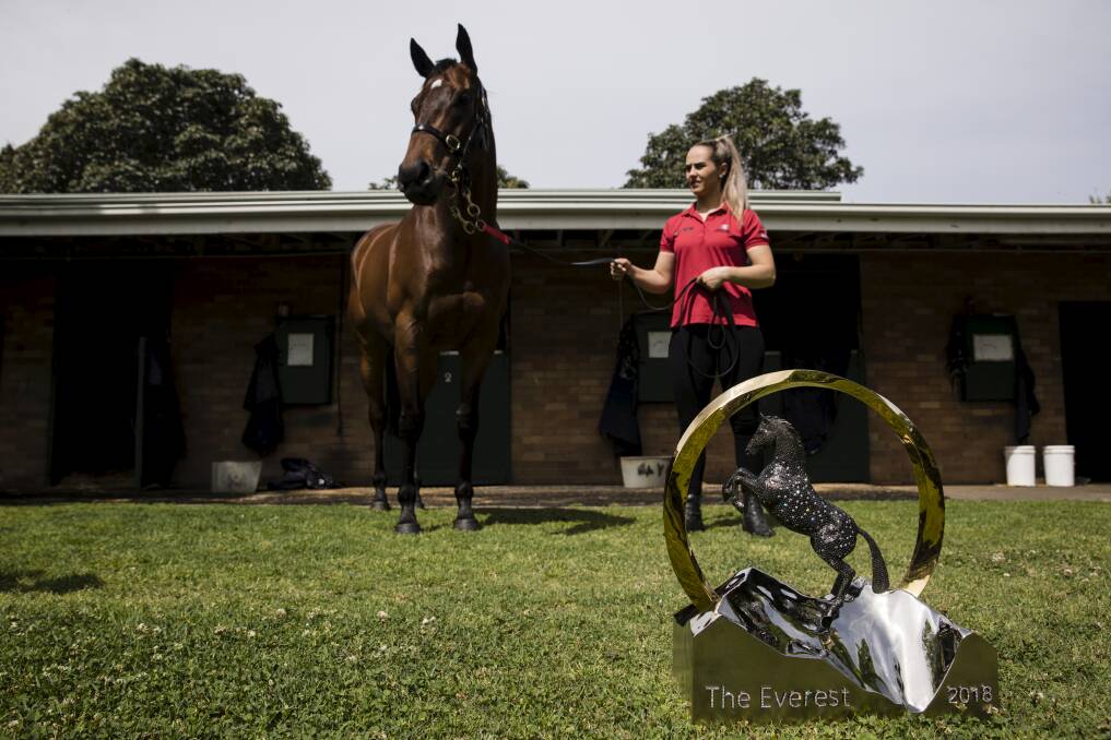 THE BIG DAY: Reigning Everest champion Redzel with strapper Christine Duffy and, in the foreground, the prize they're after this year. Photo: DOMINIC LORRIMER
