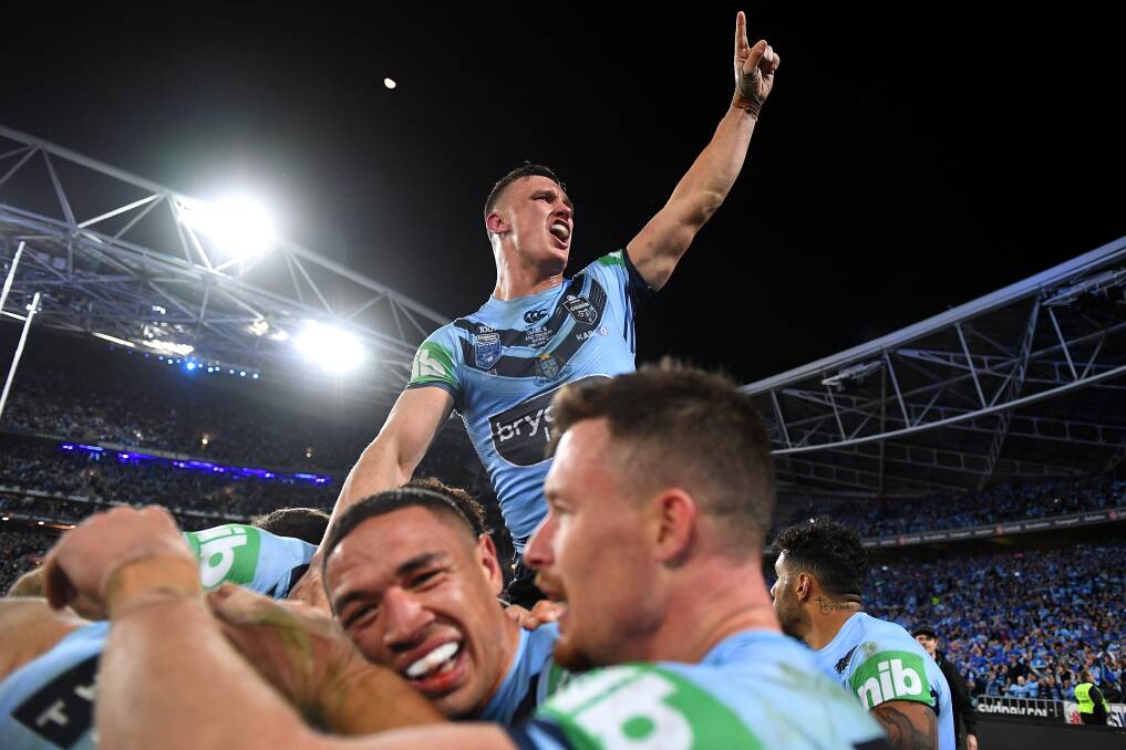 WE DID IT: Jack Wighton celebrates Wednesday night's series win with his jubliant Blues teammates on Wednesday night. Photo: AAP/DAN HIMBRECHTS