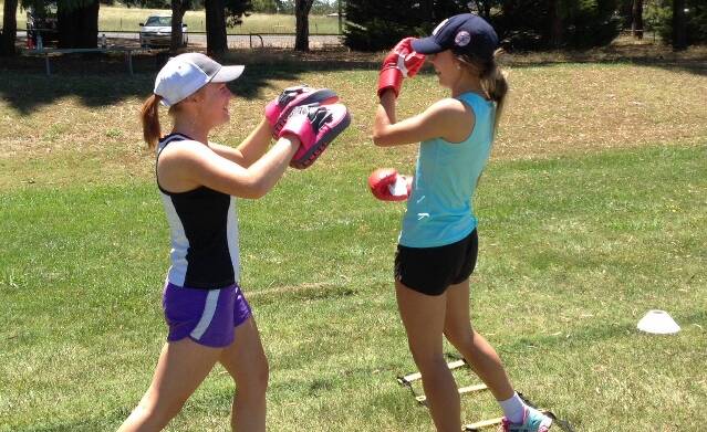 EARLY START: Feds stars Annabelle Tierney and Eva Reith-Snare enjoy a laugh at a pre-season boxing session earlier this week. Photo: CONTRIBUTED