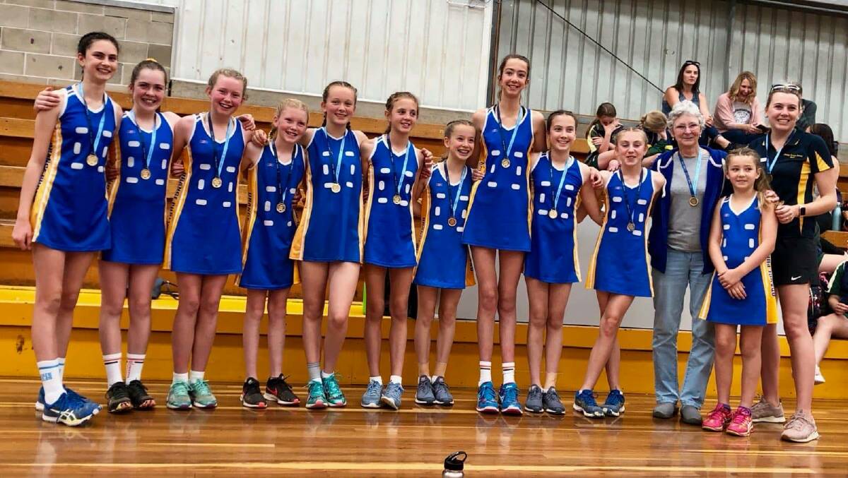 CHAMPIONS: OPS' netball side, flanked by coaches Lynne Middleton and Leasa Konza, show off their NSWPSSA Knockout medals after winning the state championship on Tuesday. Photo: CONTRIBUTED