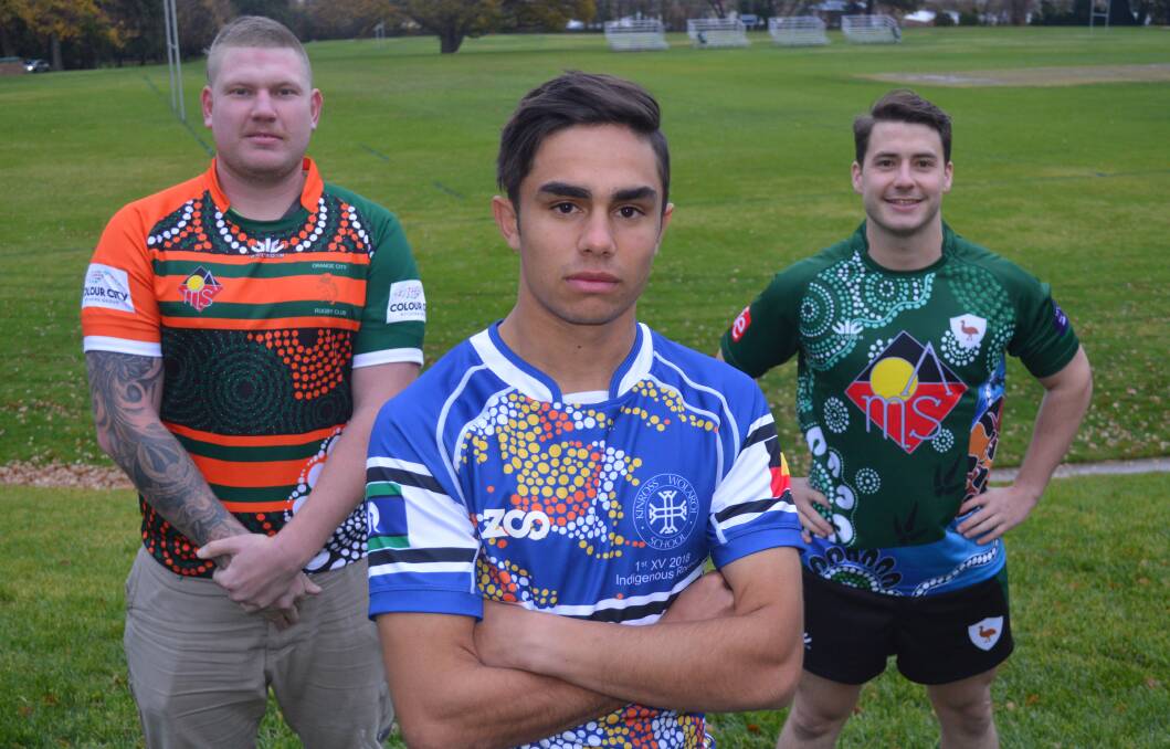 ALL IN: Orange City's Scott Smith, Kinross' Preston Simpson and Emus' Harry Cummins proudly show off their respective sides' Indigenous jerseys. Photo: MATT FINDLAY