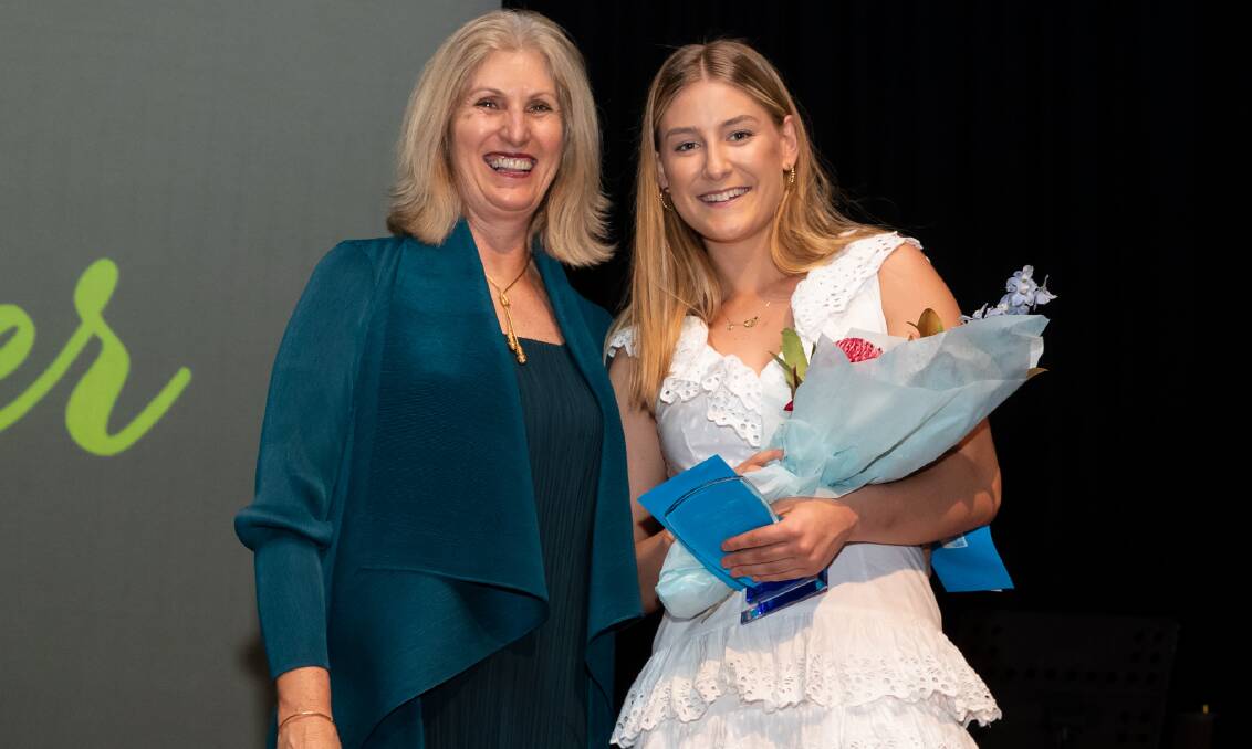 STAR PRODUCT: Annie Miller (right) is presented with the Marj Groves AM Scholarship by Netball NSW pathways manager Margaret Hamley. Photo: NARELLE SPANGHER