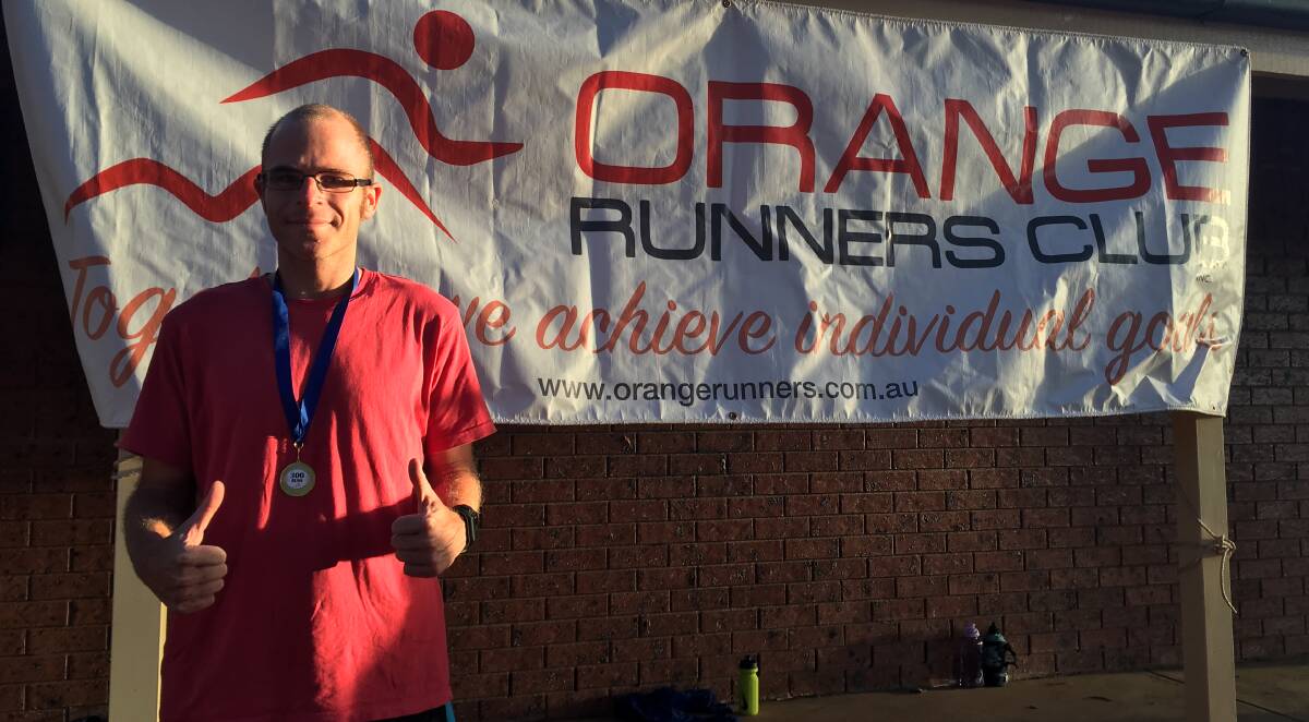 TRIPLE CENTURION: Richard Eggleston flashes a thumbs up after receiving a medal recognising his 300th run with Orange Runners Club last week. He also competed in last weekend's Australian Running Festival at Canberra. Photo: CONTRIBUTED