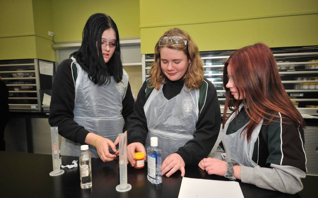 SCIENCE: Canobolas students Charlie Adams, Jack Birks and Rihanna Smith get stuck into the allied health and pharmacy workshop. Photo: JUDE KEOGH