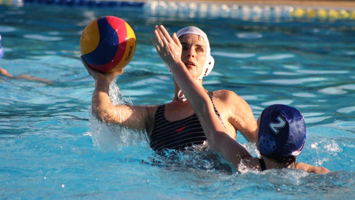 SPLASH DOWN: Spooners' Penny Greene (white cap) about to get a shot away as the Lifeguards' Shelby Archer limits the options. Photo: MICHELLE COOK 1130mcwpolo1