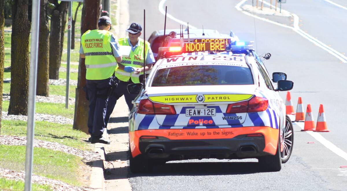TESTING: Police conduct roadside breath tests in Orange over the long weekend, largely motorists behaved well during the blitz. Photo: JUDE KEOGH