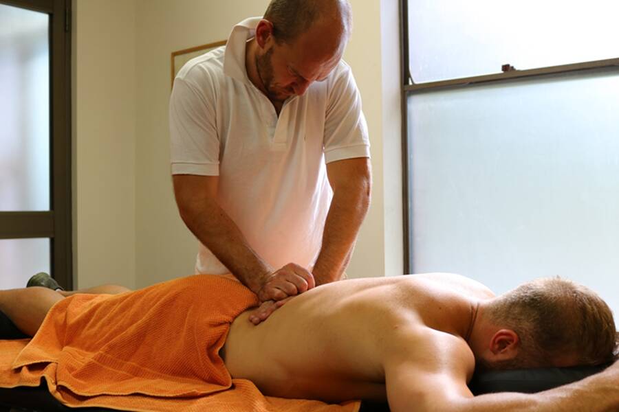 HANDS ON: Harry Fardell works on a patient. Photo: ORANGE PHYSIOTHERAPY