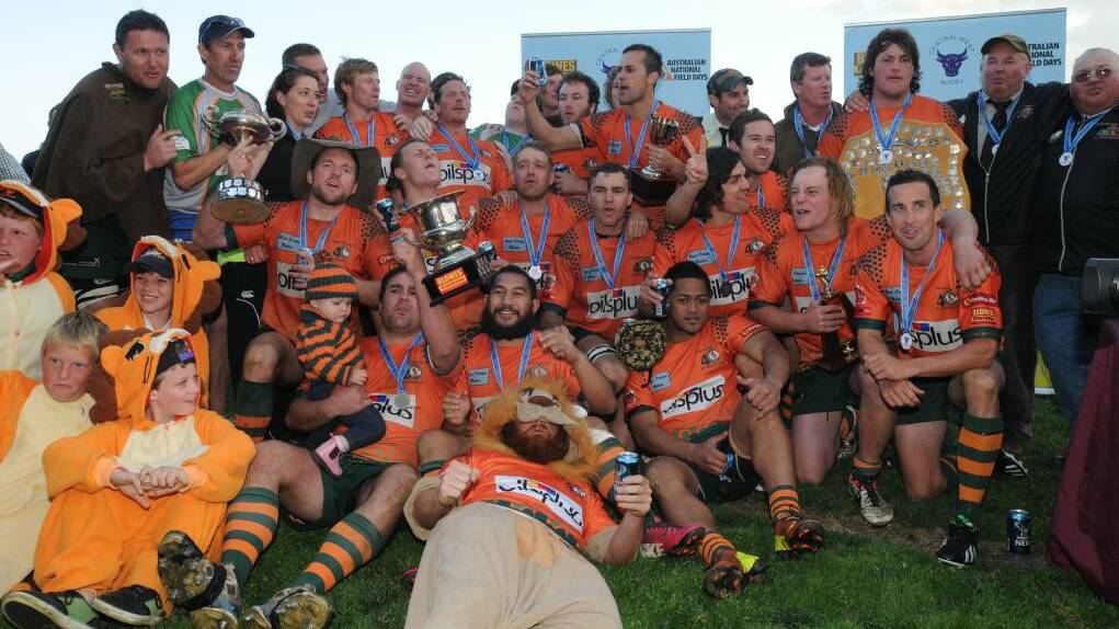 THE PRIDE LANDS: Orange City's all-conquering 2013 side celebrates their premiership, the second undefeated title the Lions claimed on the trot. Photo: STEVE GOSCH