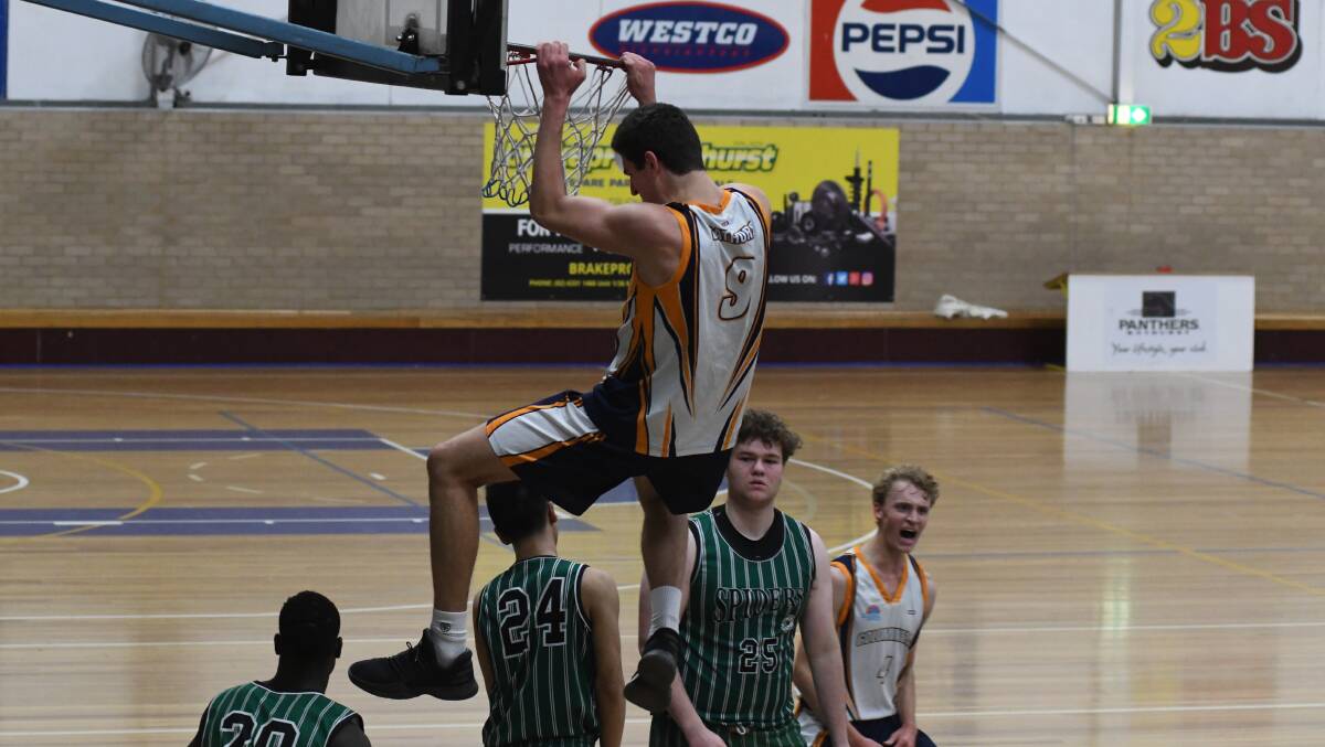 PUT IT ON A POSTER: Orange's Matt Gray slams one home in his Goldminers' win over the Hornsby Spiders on Saturday. Photo: CHRIS SEABROOK