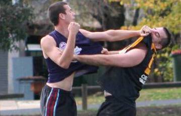 GLORY DAYS: Luke Whitton (right) gets man-handled by Cowra's Brendon Reid. Photo: KASS INGS