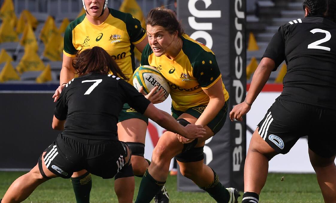 VALIANT IN DEFEAT: Grace Hamilton takes one of her 15 carries in Saturday's Test. She was strong, but her Wallaroos were outclassed by New Zealand. Photo: AAP/DAVE HUNT